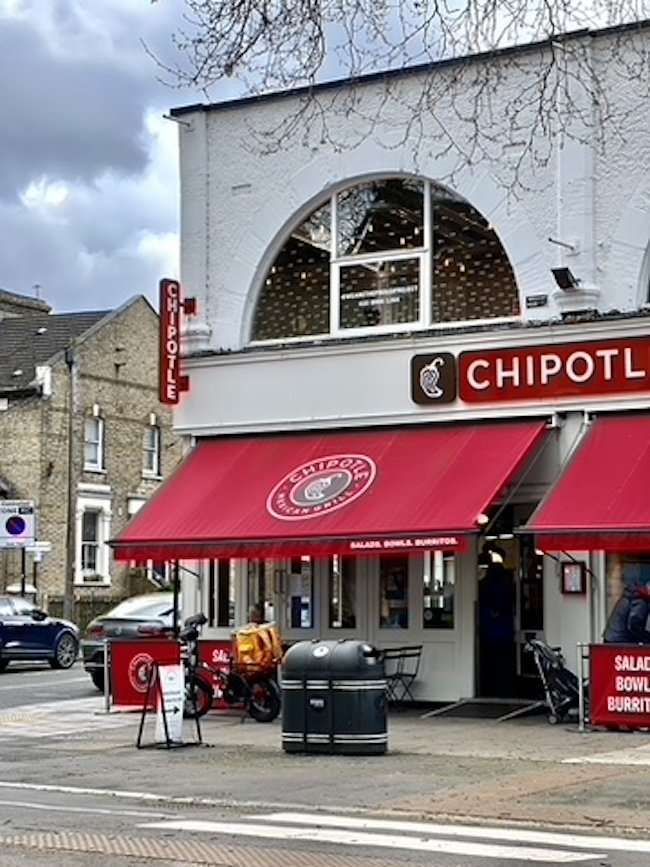 shop windows and restaurants along Chiswick High Road.